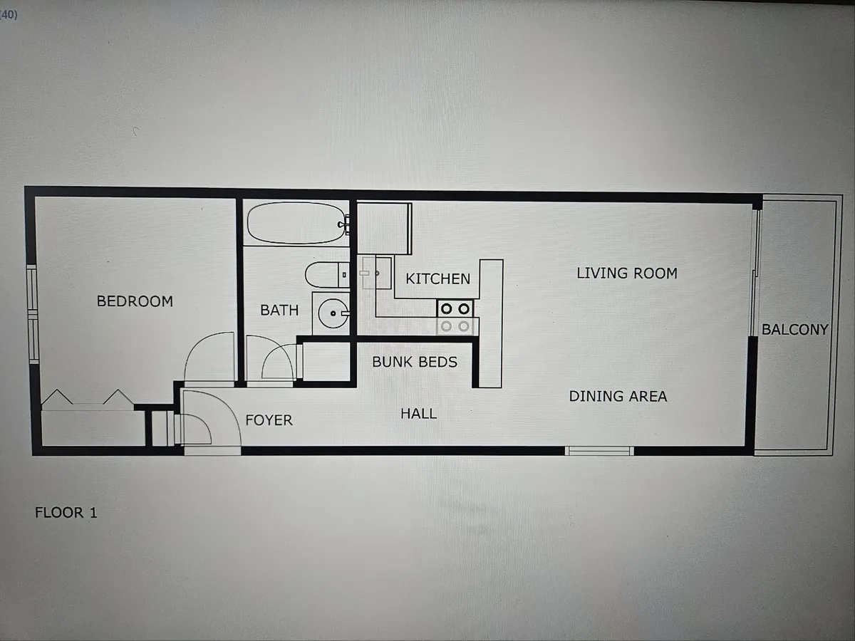An open-plan view that ties the kitchen to the broader living space, including glimpses of the foyer, living room, and a cozy dining nook. This image captures the communal aspect of the home, where the kitchen and dining area serve as the heart for gatherings, meals, and relaxation. There’s also a peek at the balcony, hinting at beachside proximity.